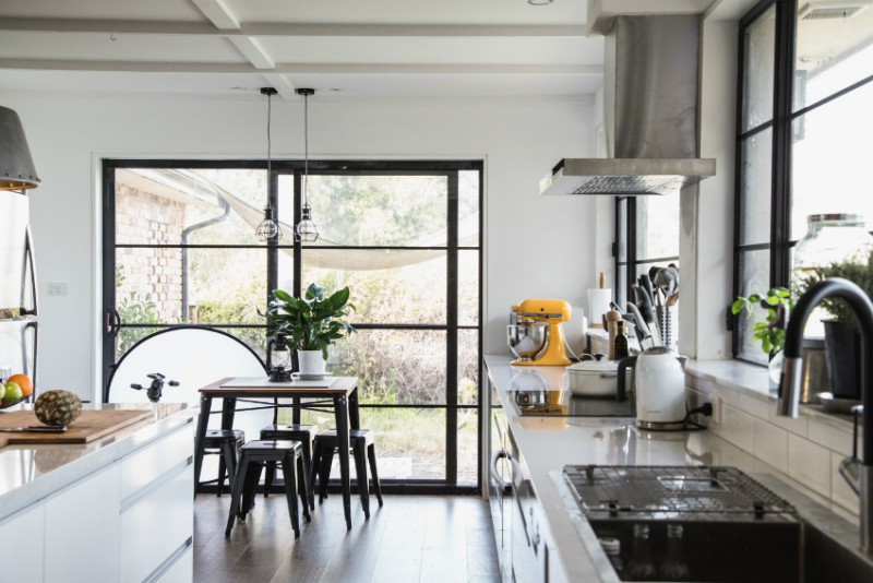 С помощью раздвижных панорамных окон обеденную зону кухни можно объединить с выходом во двор